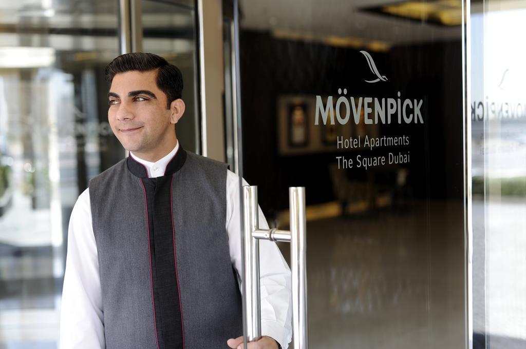 Moevenpick Hotel Apartments Al Mamzar Дубай Екстериор снимка A doorman at a hotel in Dubai